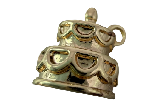 Tiered celebration cake charm in white enamel with glossy gold detailing