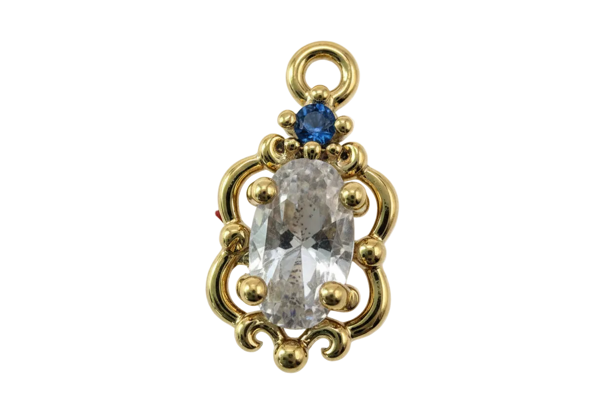 Gold ornate frame with clear faceted oval gem and small blue gem accent