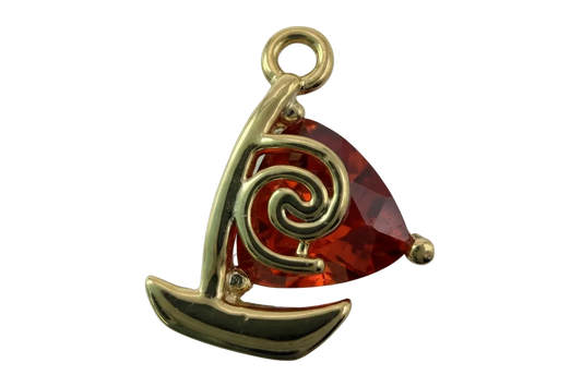 Gold sailboat charm with faceted red gem sail and swirl detail