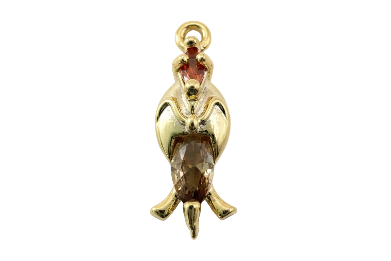 Gold penguin charm with faceted amber crystal body and small red crystal accent