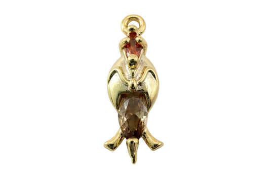 Gold penguin charm with faceted amber crystal body and small red crystal accent