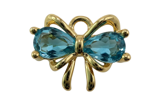 Gold bow knot with two faceted aqua-blue oval gems