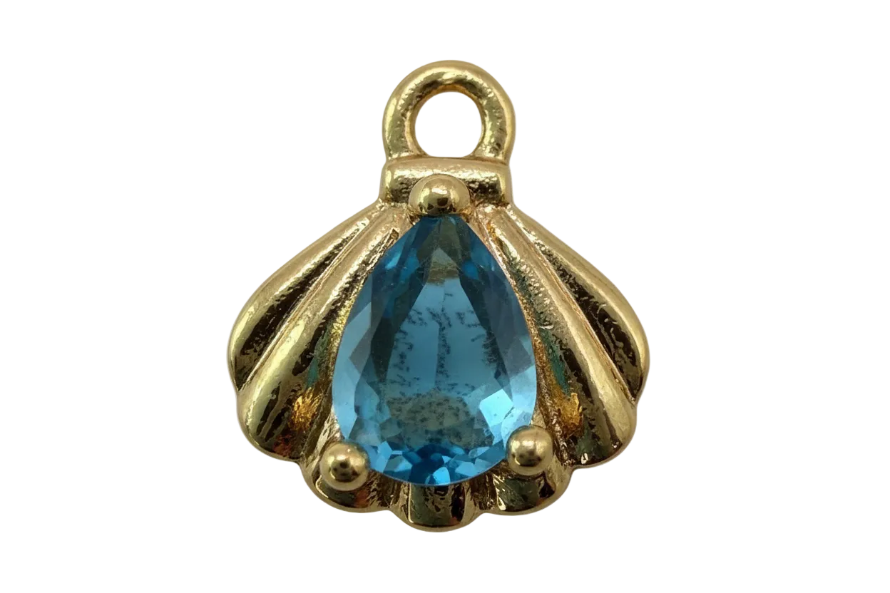 Gold scallop shell charm with faceted blue teardrop gem