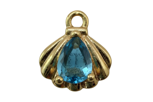 Gold scallop shell charm with faceted blue teardrop gem