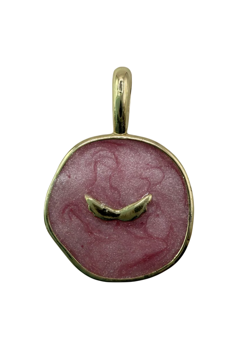 Pink marbled round disc with polished gold border and curved center bar