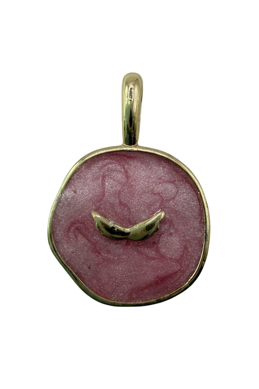 Pink marbled round disc with polished gold border and curved center bar