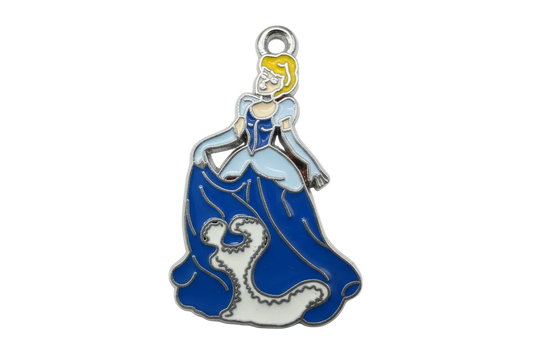 Blue and white enamel ocean wave with a surfer figure, silver-tone outline and yellow hair
