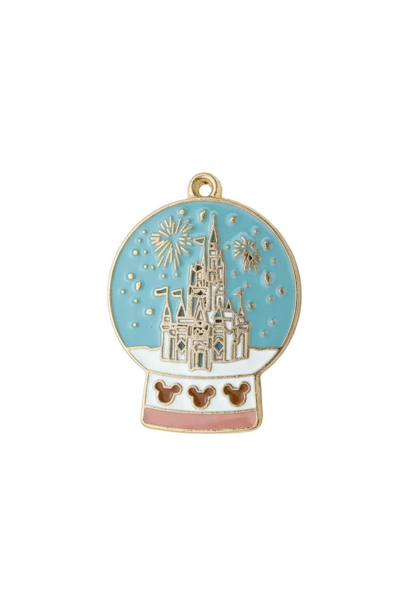 Gold enamel snow globe with castle and fireworks on blue