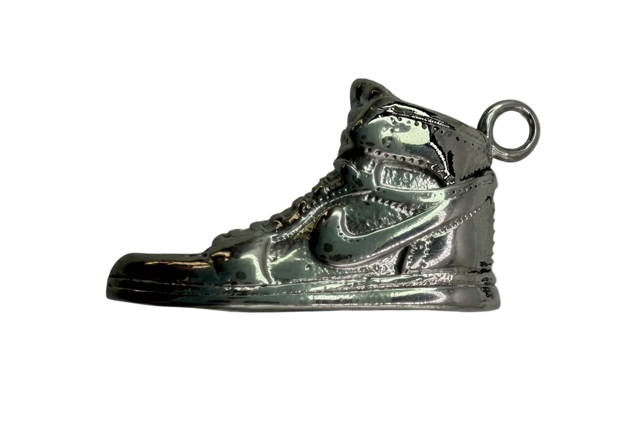 Polished silver high-top sneaker charm with sculpted tread and lace details