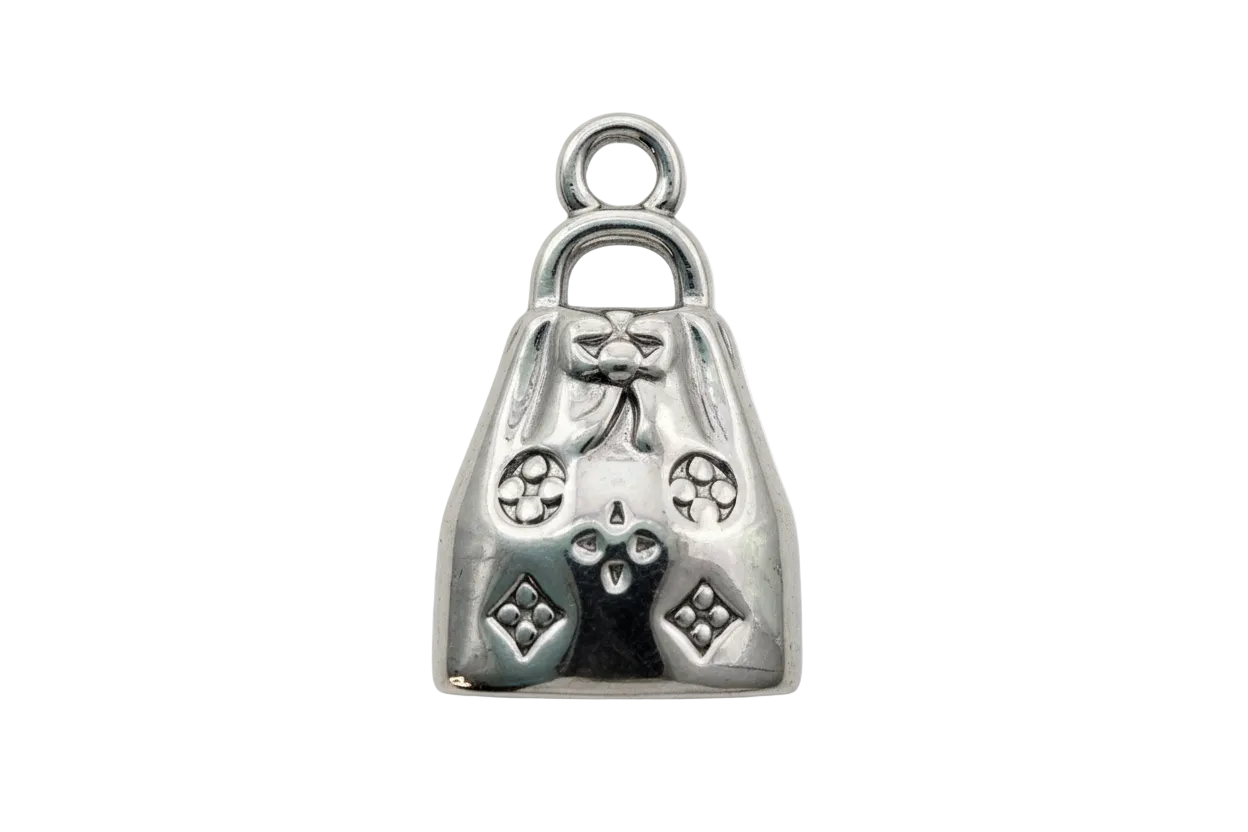 Polished silver handbag charm with bow detail and raised geometric accents