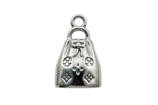 Polished silver handbag charm with bow detail and raised geometric accents