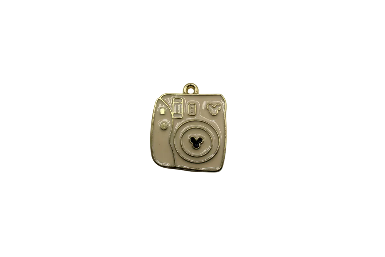Taupe enamel instant camera with gold outline and black icon