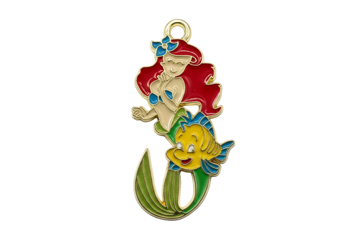Gold-outlined enamel mermaid with red hair, green tail, and a yellow fish with blue fins