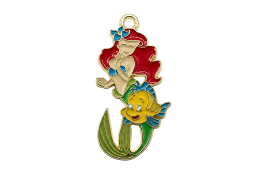 Gold-outlined enamel mermaid with red hair, green tail, and a yellow fish with blue fins