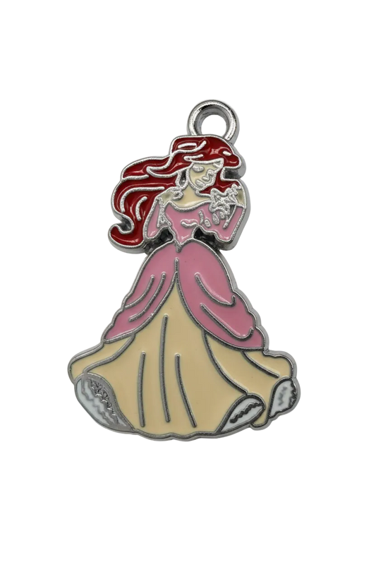 Glossy enamel mermaid with red hair, pink fin details, and beige tail, outlined in silver