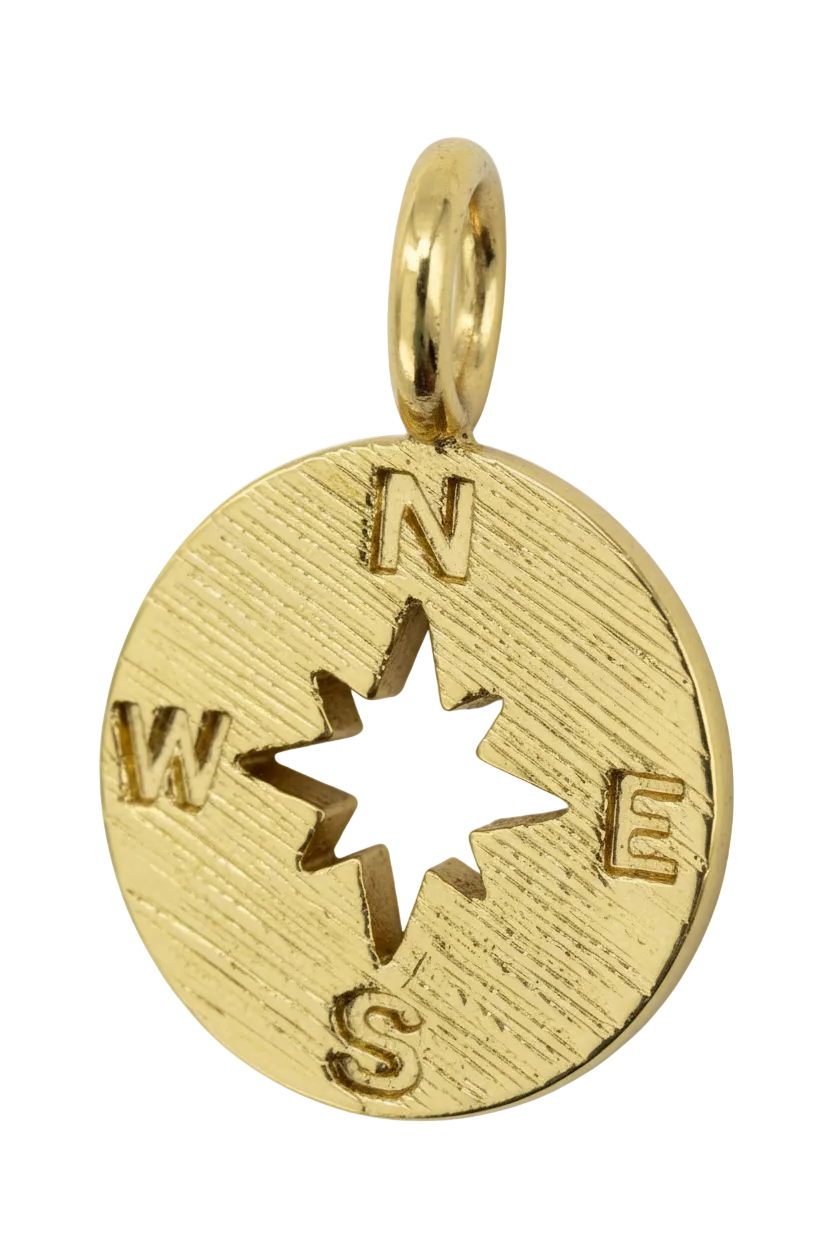 Textured gold compass coin with star cutout center and directional letters