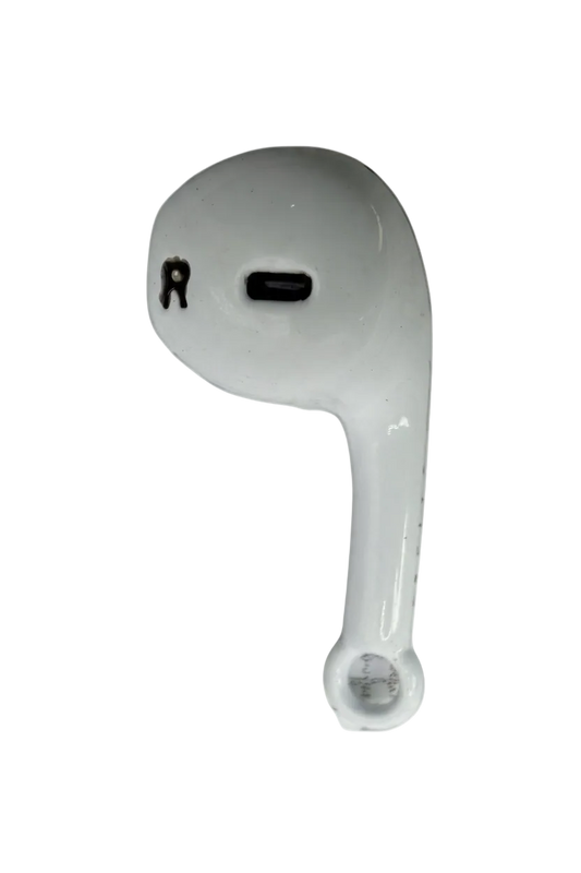 Glossy white wireless earbud charm with black detailing on a black background