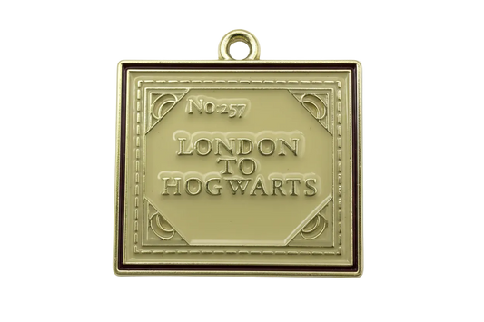 Gold book charm with glossy ivory enamel cover, raised lettering, and burgundy border