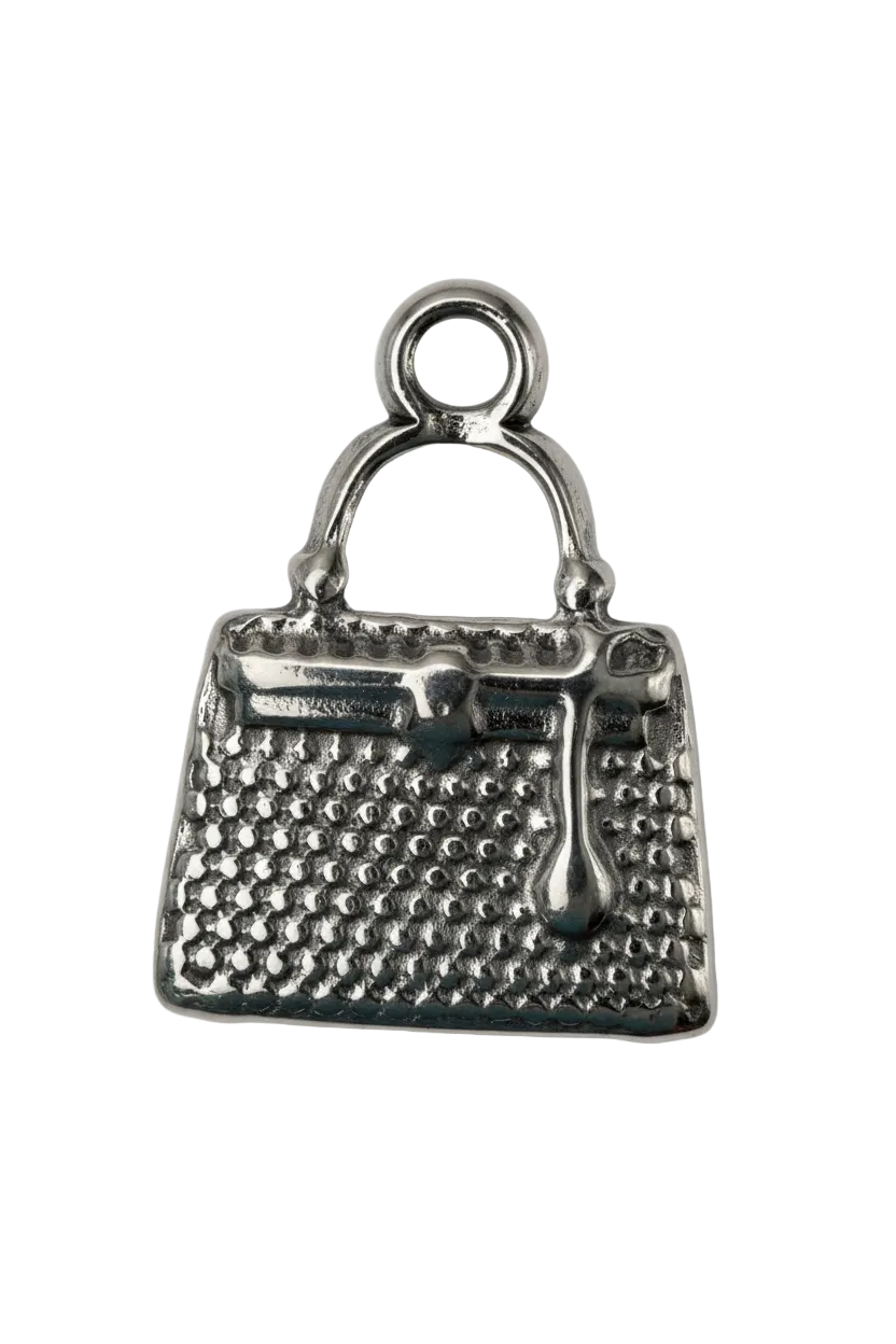 Silver handbag pendant with textured surface and curved handle
