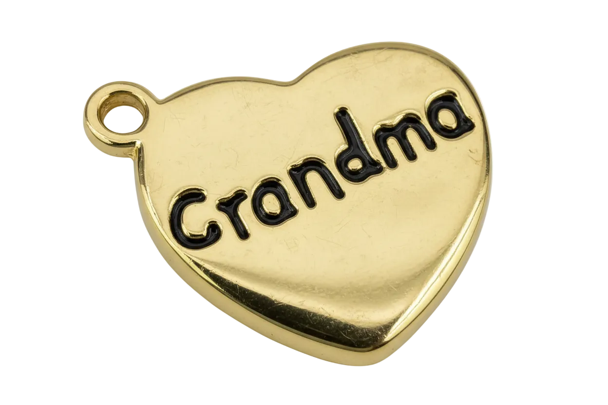 Polished gold heart with black script lettering that reads “Grandma”