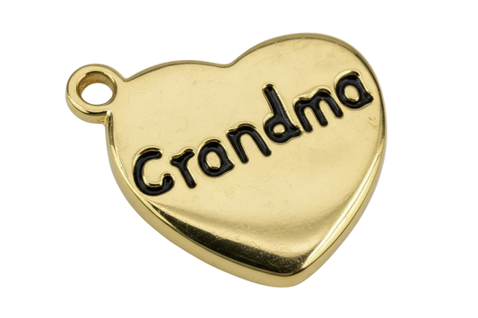 Polished gold heart with black script lettering that reads “Grandma”