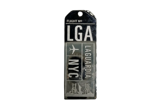 Black and silver airport code ticket tag with plane icon and skyline graphic