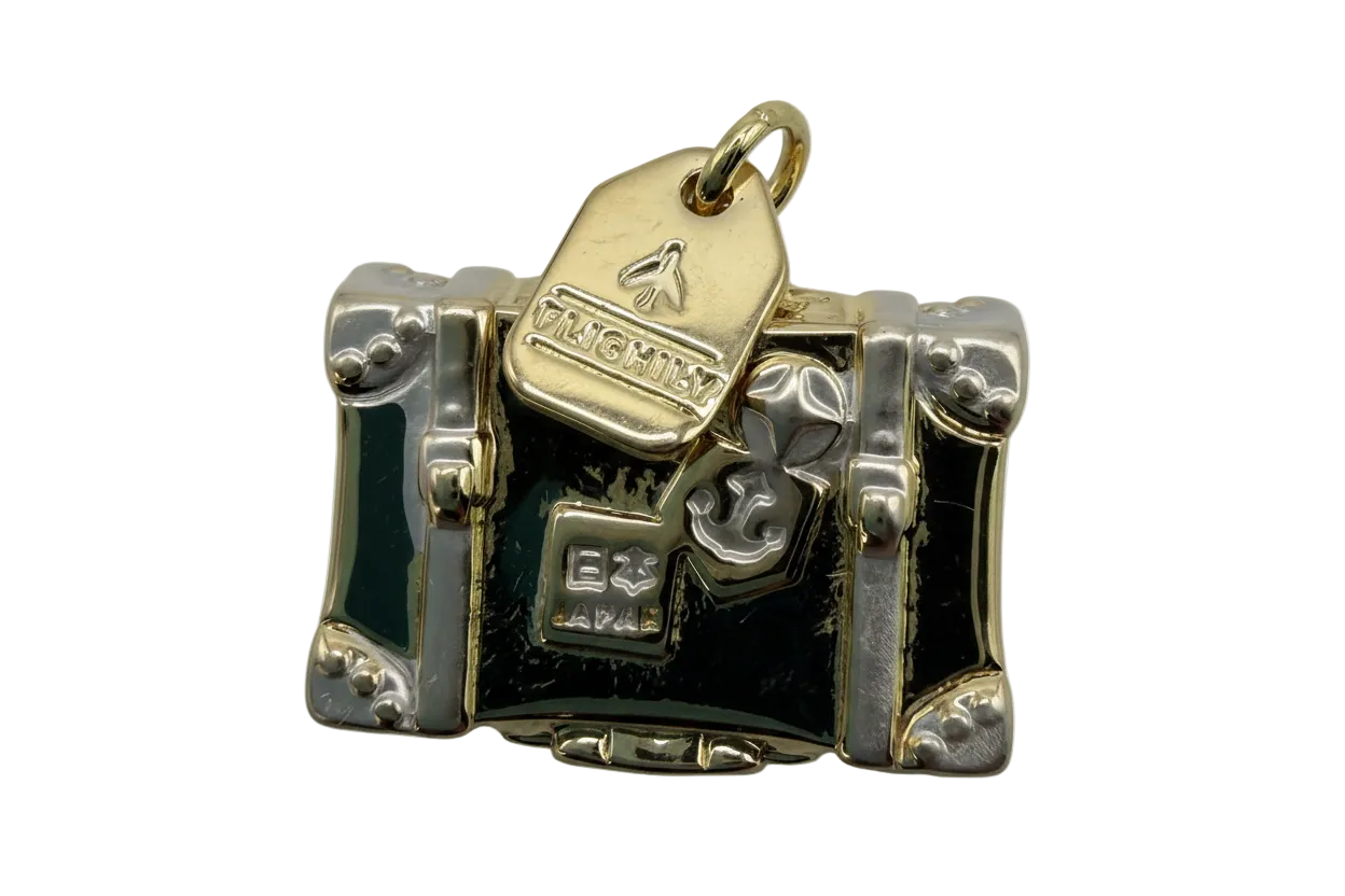 Two-tone suitcase trunk charm with glossy black panels, gold tag detail, and silver corner accents
