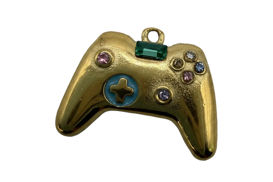 Gold game controller charm with green rectangular gem, blue enamel detail, and multicolor crystals