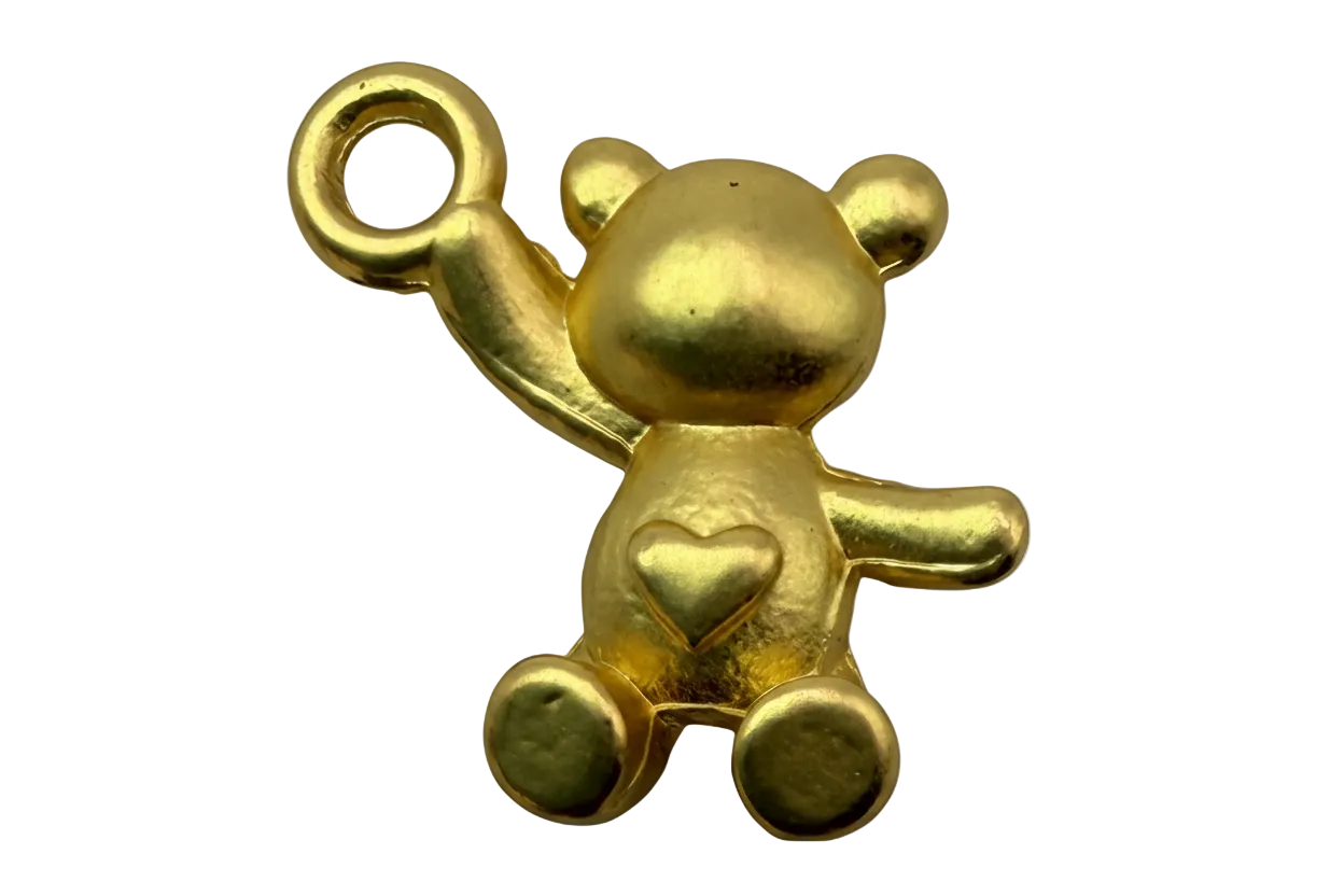 Polished gold teddy bear figure with raised arm and small heart detail on belly