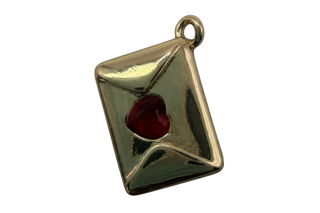 Polished gold envelope charm with a red heart-shaped gem seal