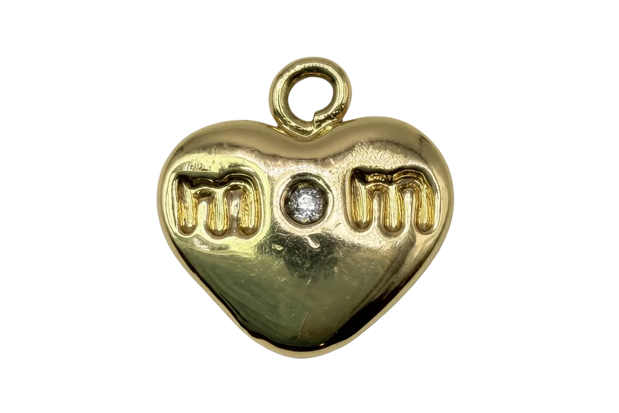 Polished gold heart with “mom” lettering and a centered clear gem