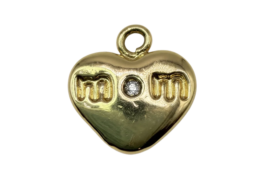 Polished gold heart with “mom” lettering and a centered clear gem