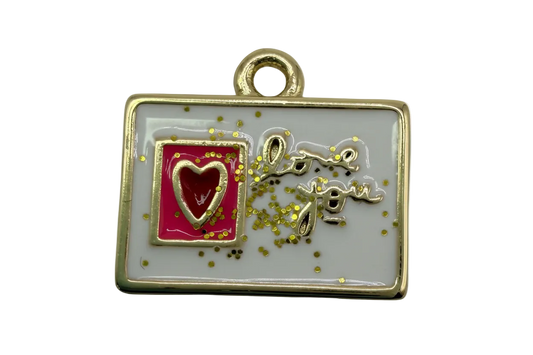 Gold-framed white enamel rectangle with raised 'love you' script, pink panel, red heart, and gold confetti