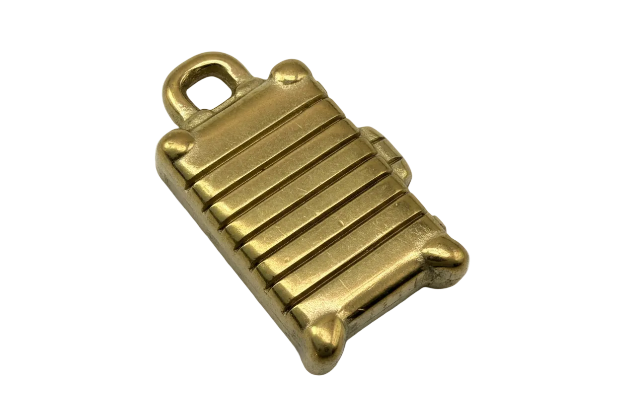 Gold ridged suitcase charm with handle and small wheel details