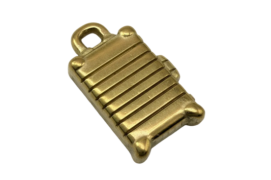 Gold ridged suitcase charm with handle and small wheel details
