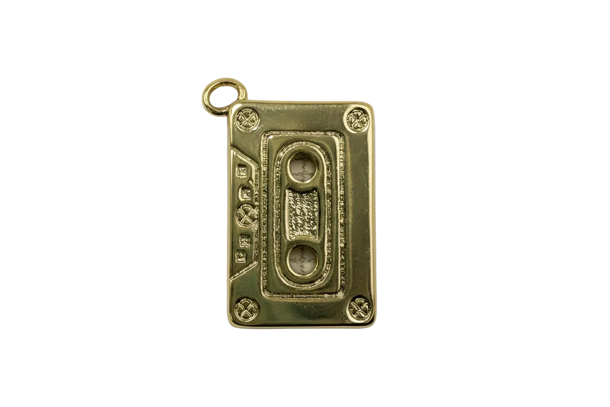 Gold cassette tape charm with marbled white gem accents and textured details