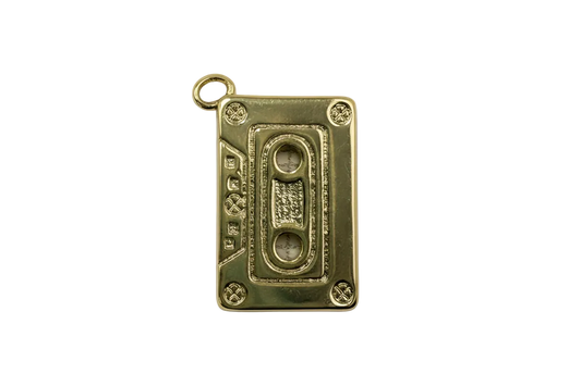 Gold cassette tape charm with marbled white gem accents and textured details