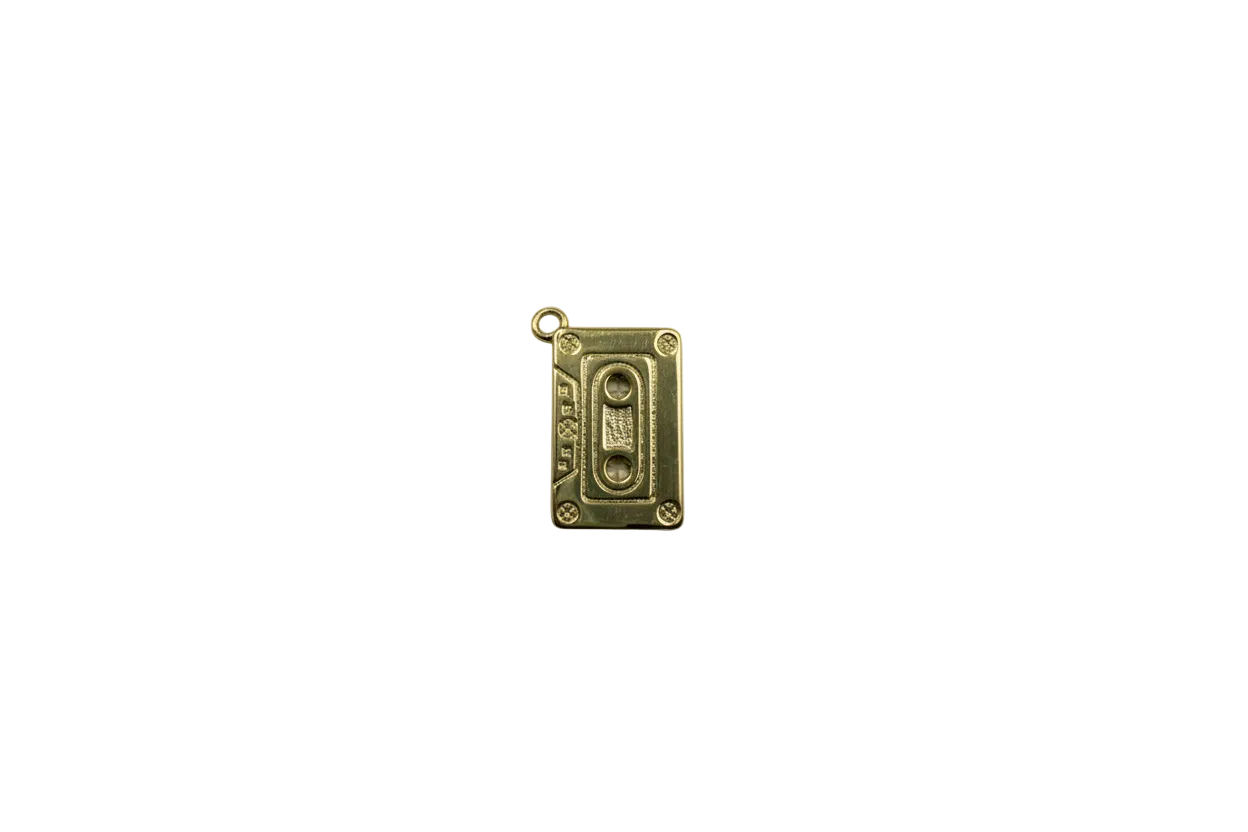 Gold cassette tape with marbled white gem accents