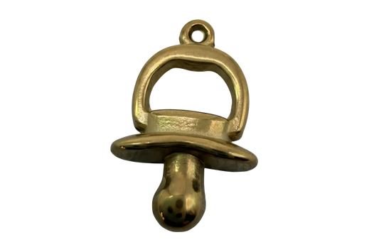 Polished gold pacifier charm with rounded, high-shine finish
