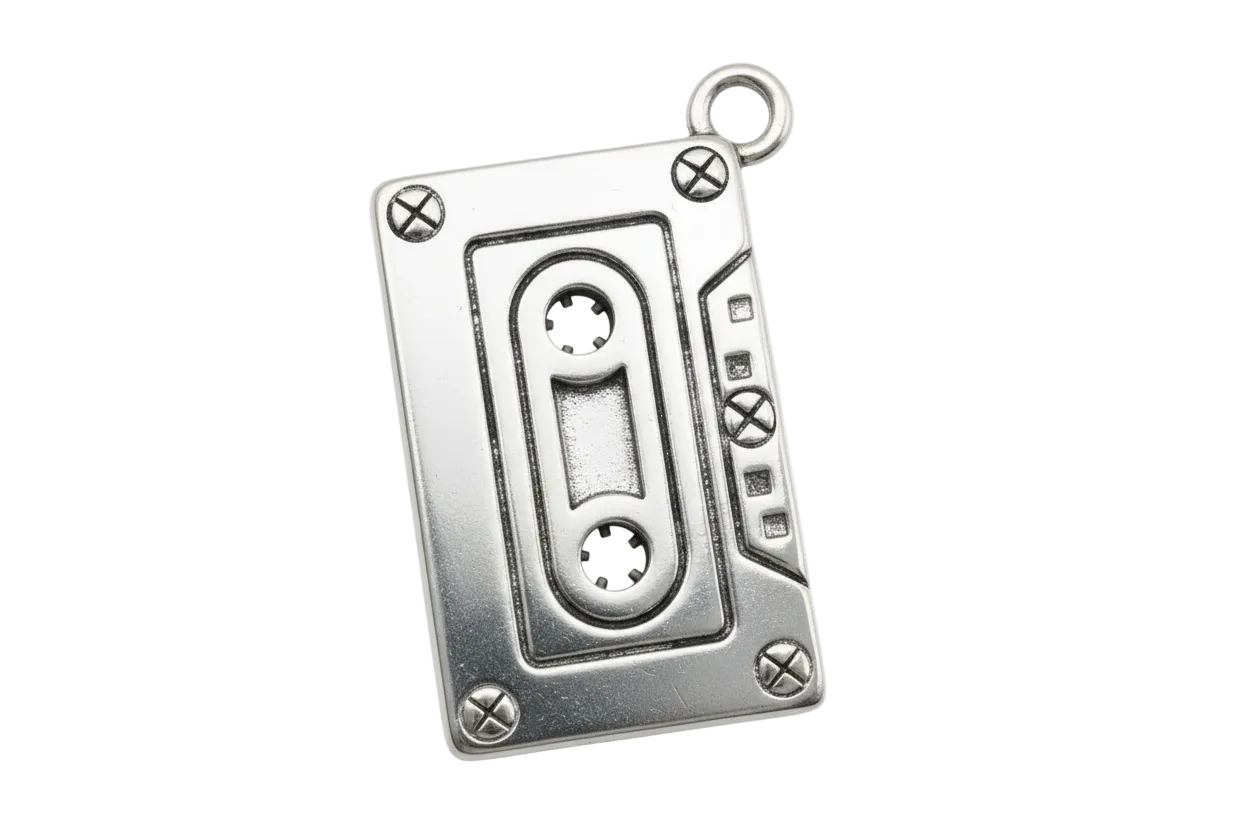 Polished silver cassette tape charm with engraved reel and screw details
