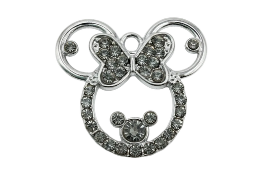 Silver mouse head silhouette with bow, outlined in clear crystals on polished metal