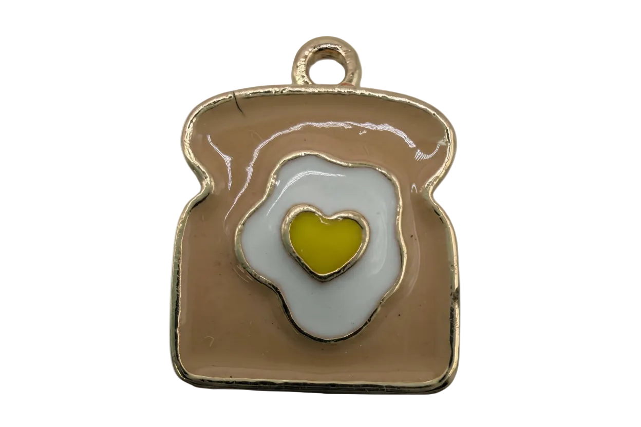 Gold-tone toast with white fried egg and yellow heart yolk enamel