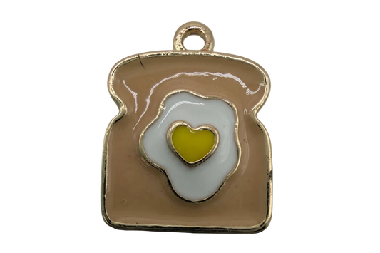 Gold-tone toast with white fried egg and yellow heart yolk enamel