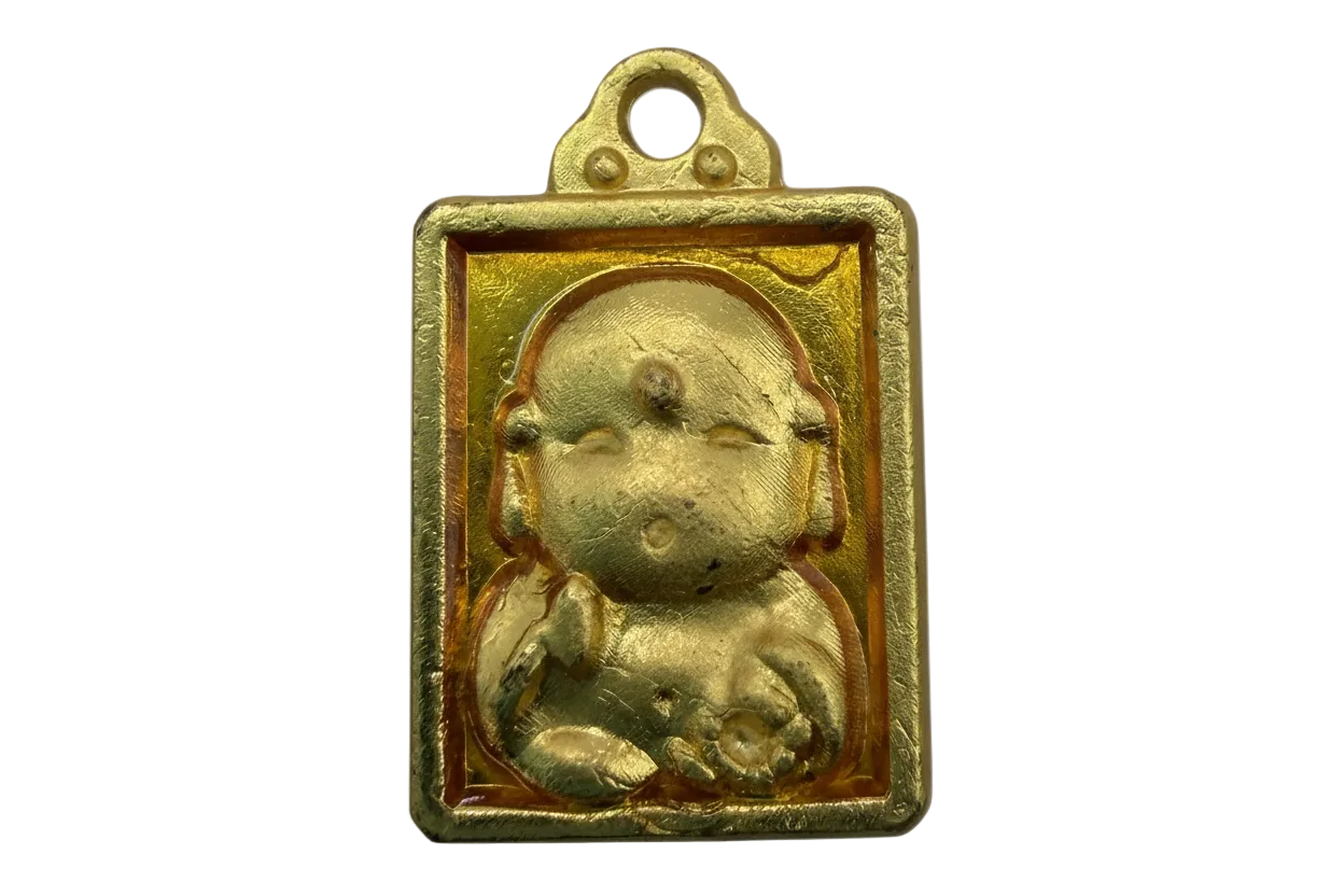 Gold rectangular plaque with raised seated baby figure and amber-toned background