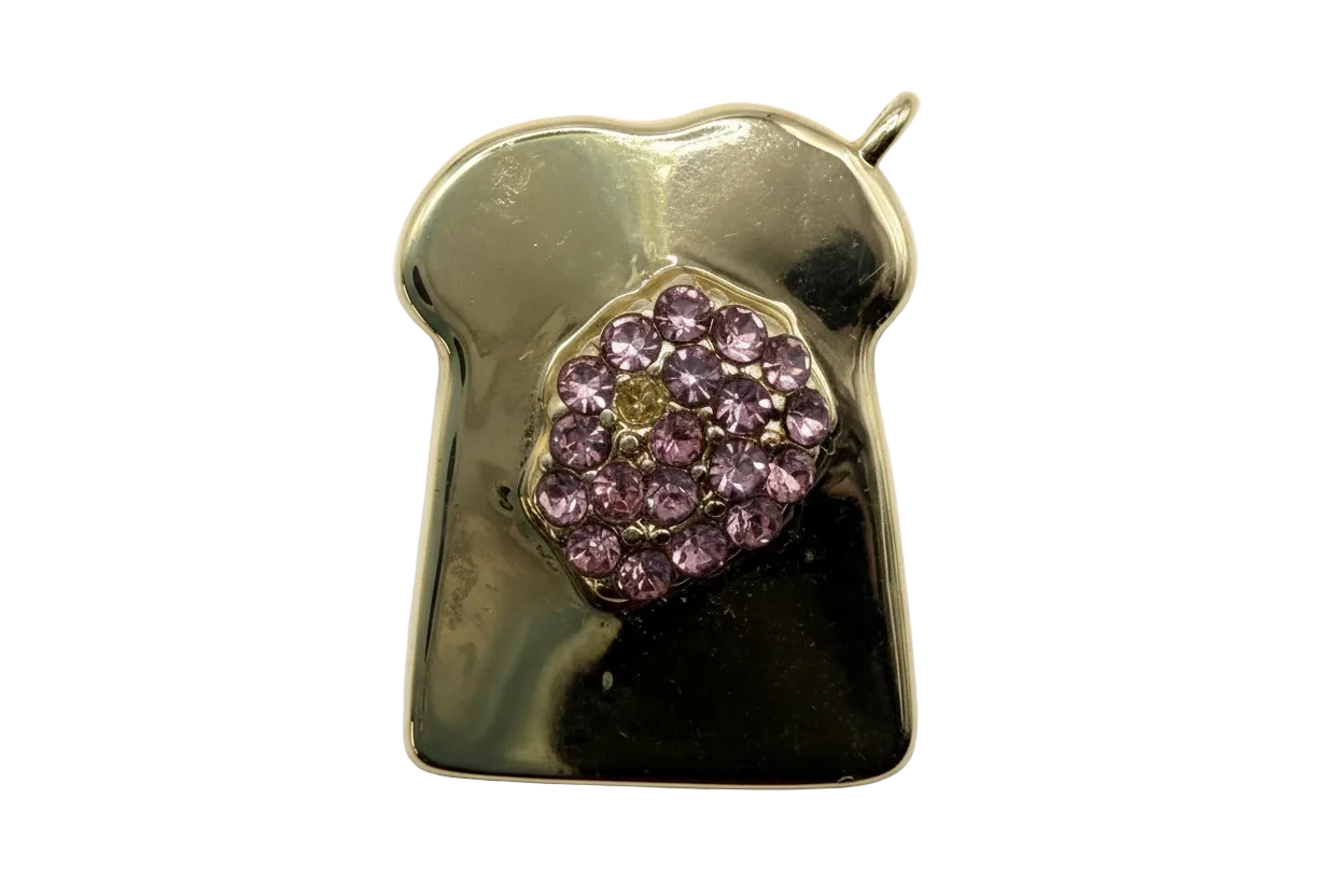 Polished gold toast slice with clustered faceted purple crystals at center