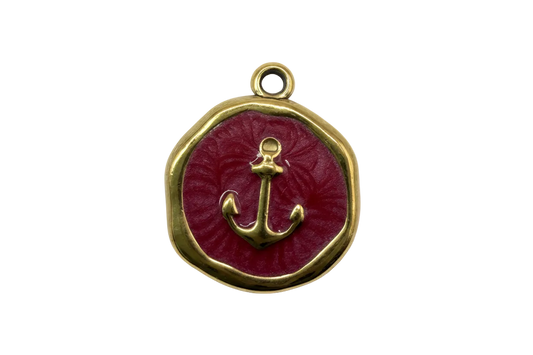 Gold anchor medallion with glossy red enamel center and rounded square frame