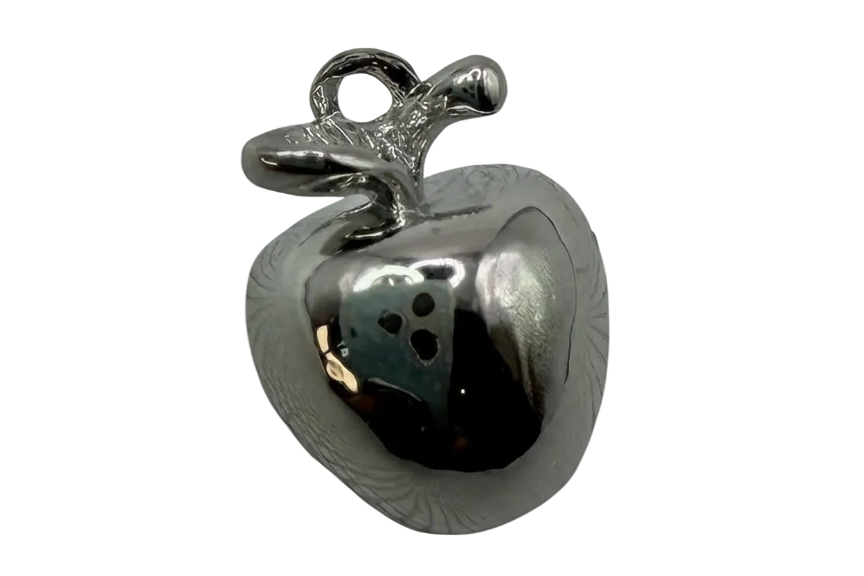Mirror-polished silver apple charm with sculpted leaf and smooth rounded body