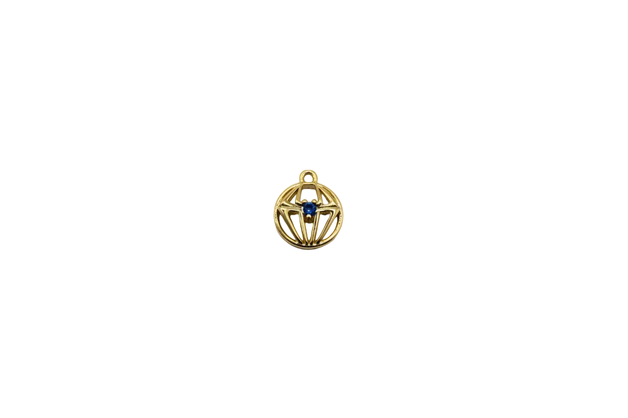 Gold spiderweb medallion with blue center gem