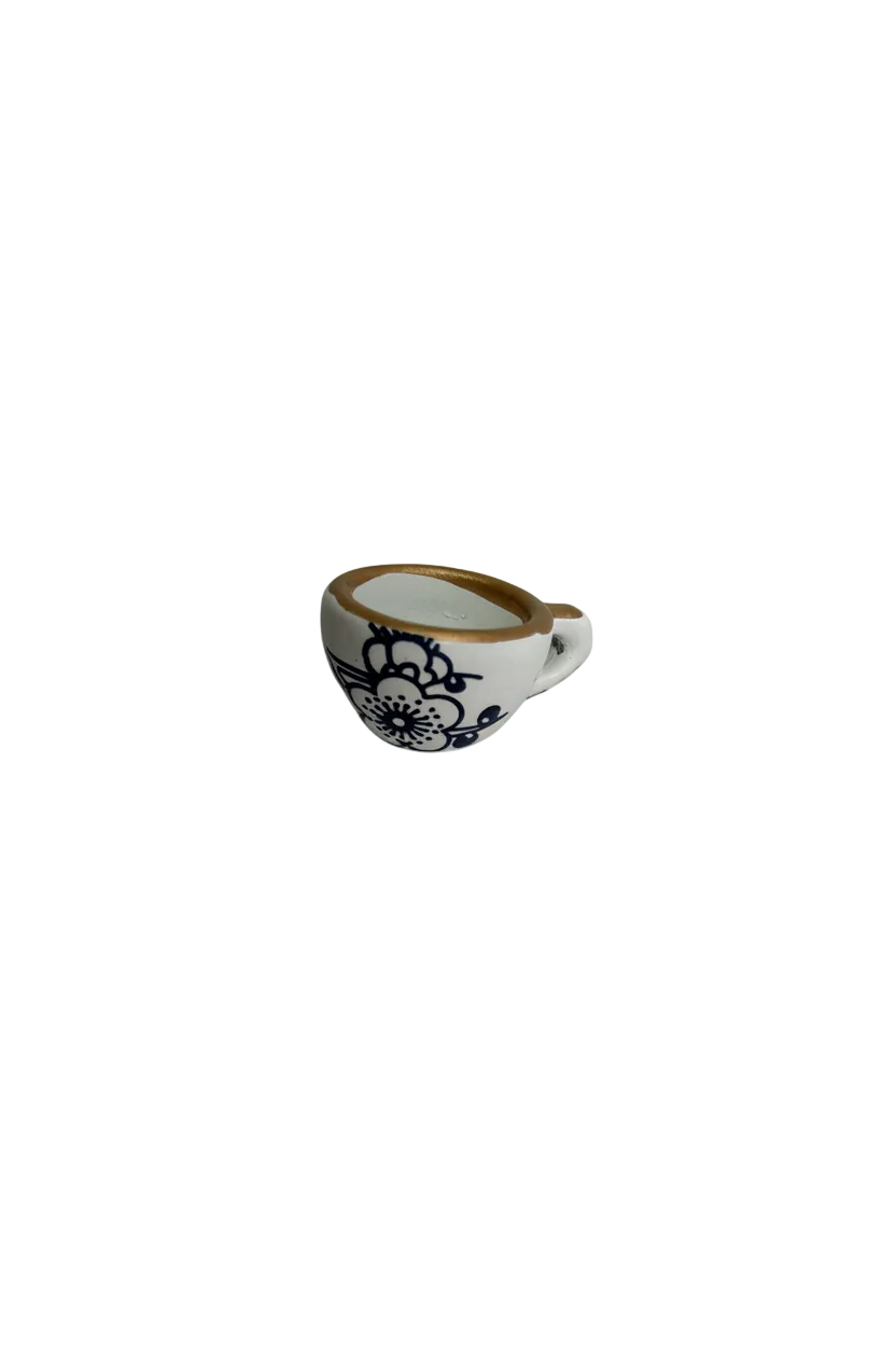 White porcelain teardrop with blue floral print and gold rim