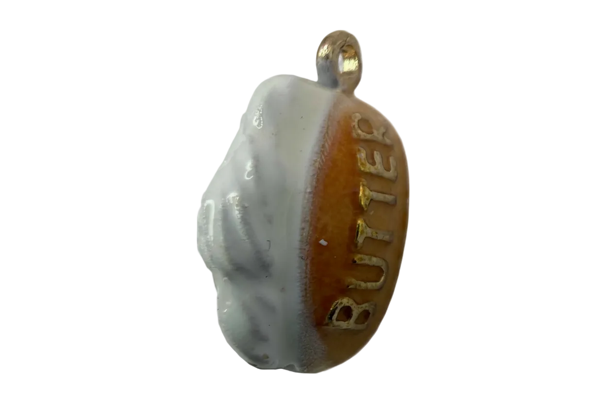 Glossy butter biscuit charm in gold with white icing and raised BUTTER lettering